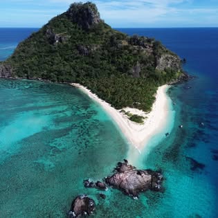Rocky Mamanuca island with a sand spit and turquoise lagoon