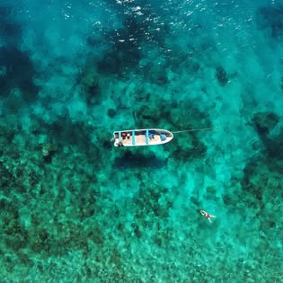 Faith Brothers boat over clear turquoise reef in the Mamanucas