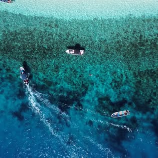 Two boats running across the reef in the Mamanucas